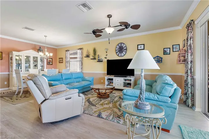 Living room featuring light hardwood / wood-style flooring and ornamental molding