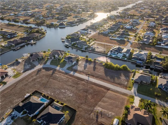 Aerial view of property's location featuring nearby suburban area and a nearby body of water