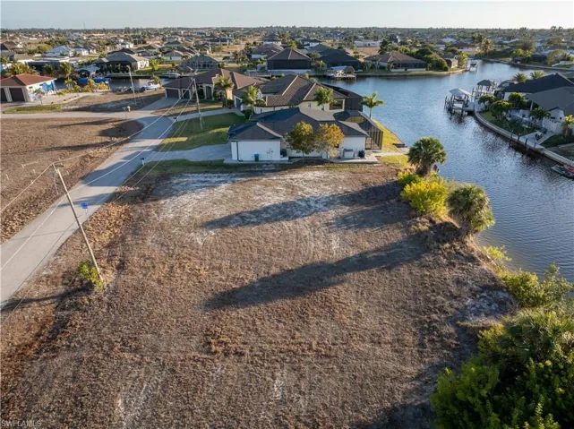 Aerial perspective of suburban area with a nearby body of water