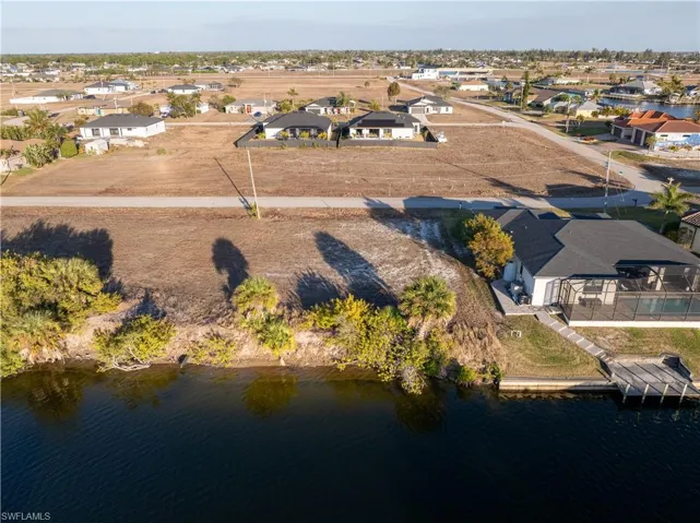 View of property location featuring a large body of water and nearby suburban area