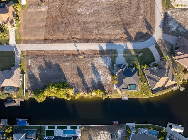 Aerial view of residential area featuring a large body of water