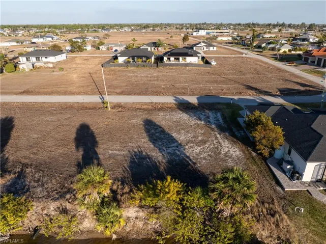 Aerial view of property's location with nearby suburban area