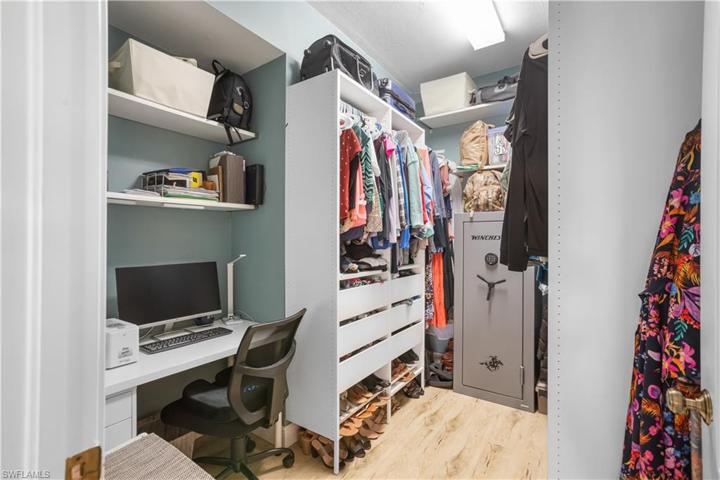 Primary Walk In Closet with built-in desk area