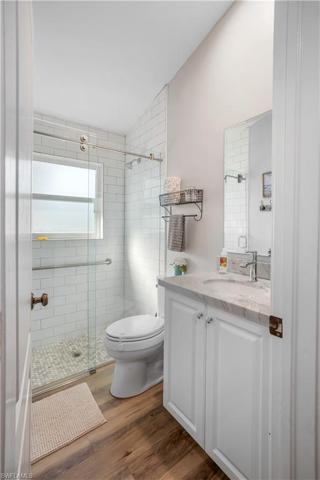 Guest Bath with sliding glass door and quartz counters