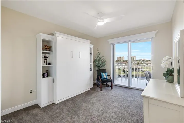 Unfurnished room featuring ceiling fan and carpet