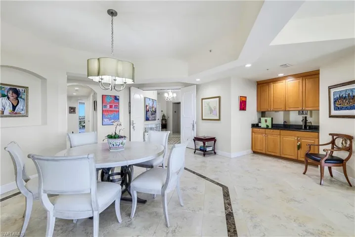 Dining room with sink and a chandelier