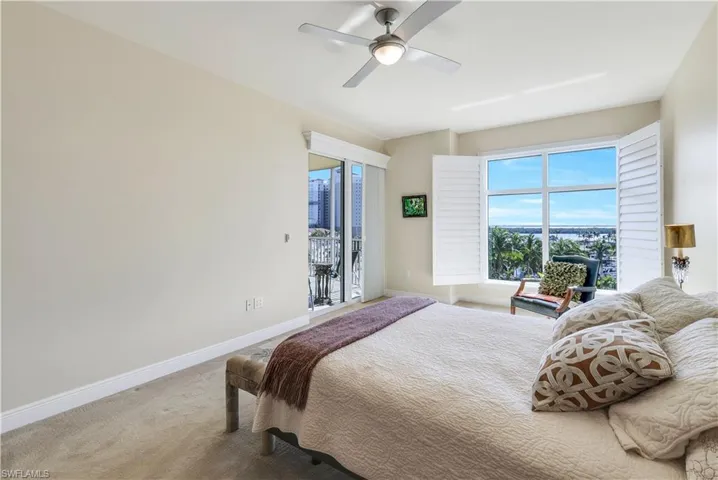 Bedroom with access to outside, ceiling fan, and carpet floors