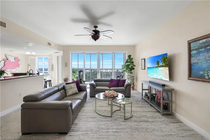 Living room with a wealth of natural light and ceiling fan