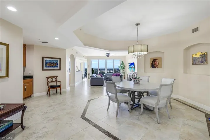Dining room featuring ceiling fan with notable chandelier