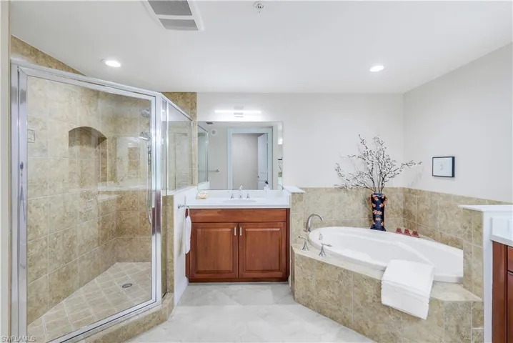 Bathroom with vanity and shower with separate bathtub