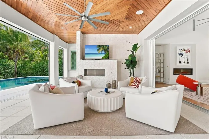 Imagine entertaining poolside while catching the game fireside, an inviting setting designed for relaxed Naples living