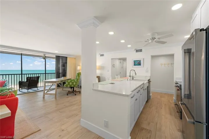 Open concept living space featuring wood-finish flooring and direct access to a screened balcony