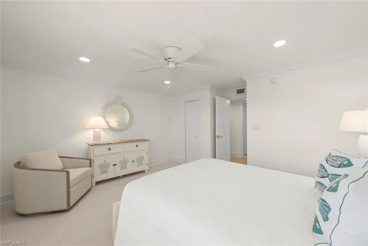 Bright bedroom featuring recessed lighting, a ceiling fan, crown molding, and carpet flooring