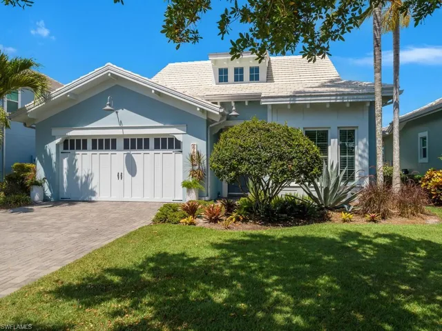 View of front of home featuring stucco siding, a front lawn, an attached garage, and decorative driveway