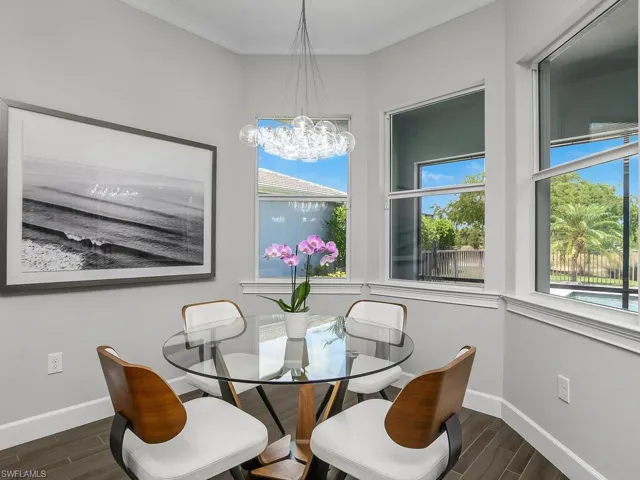 Dining room with plank-style floors, a chandelier, and crown molding