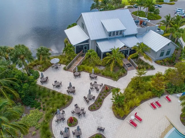 Aerial view of property and surrounding area featuring a nearby body of water