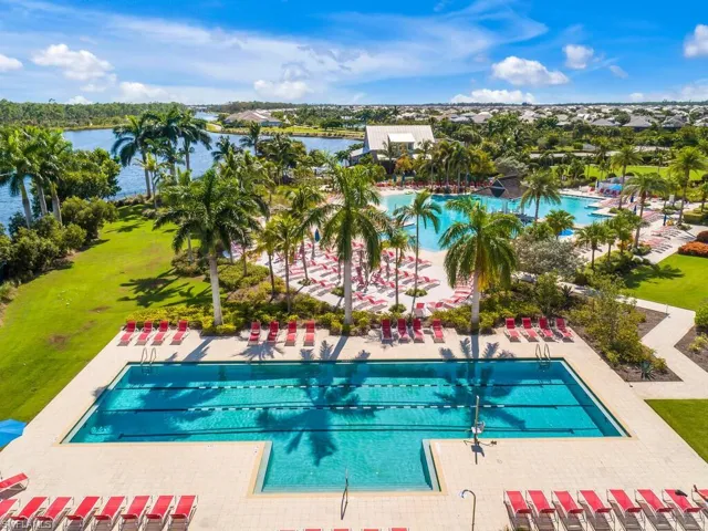Community pool with a water view and a patio area