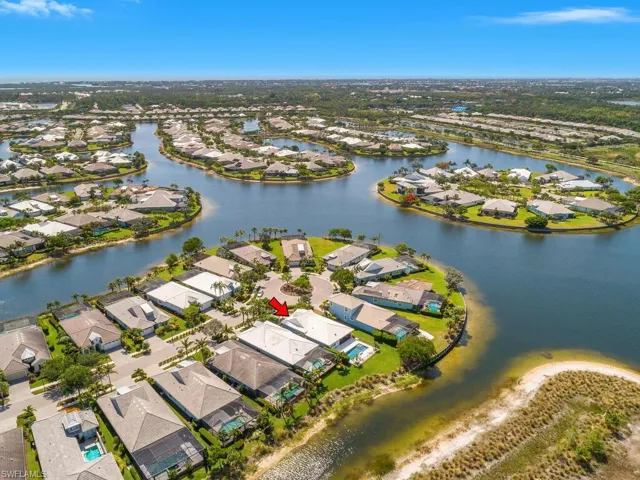 Aerial view of property's location featuring nearby suburban area and a nearby body of water