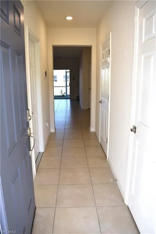 Corridor featuring light tile patterned flooring and recessed lighting
