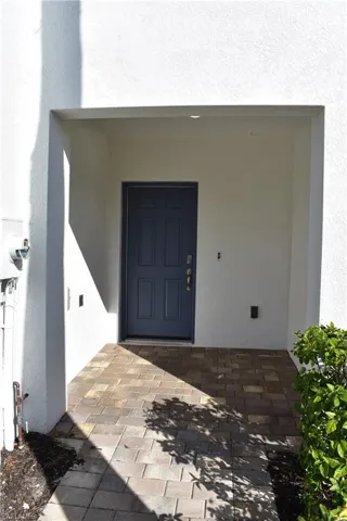 Entrance to property with stucco siding