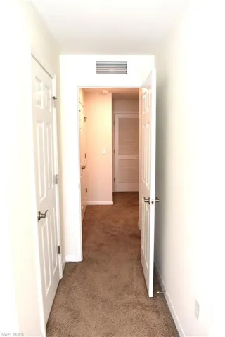 Hall with carpet and baseboards