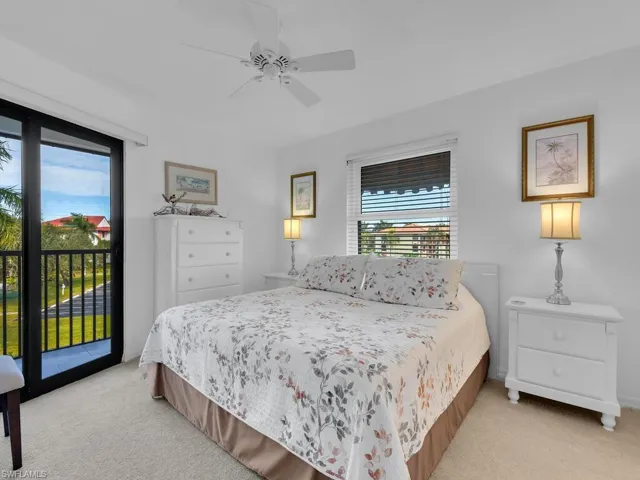 Bedroom featuring light carpet, access to outside, and ceiling fan