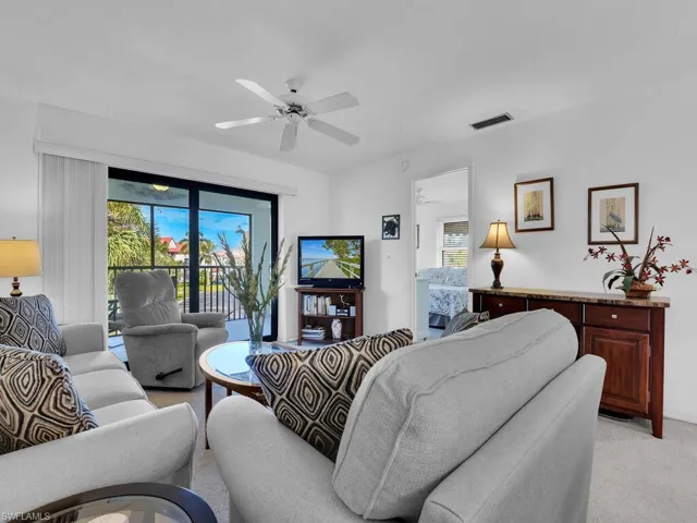 Living room with light carpet and ceiling fan