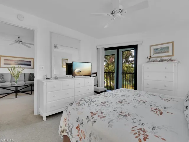 Carpeted bedroom featuring access to exterior and ceiling fan