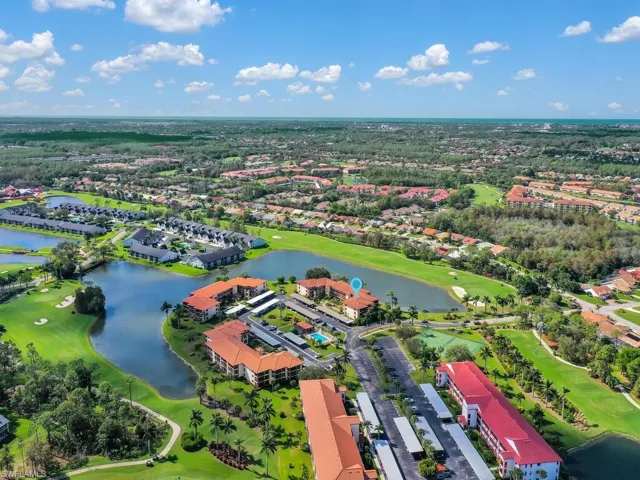 Birds eye view of property with a water view