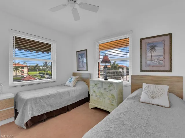 Bedroom with ceiling fan and carpet