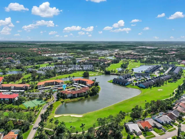 Birds eye view of property with a water view