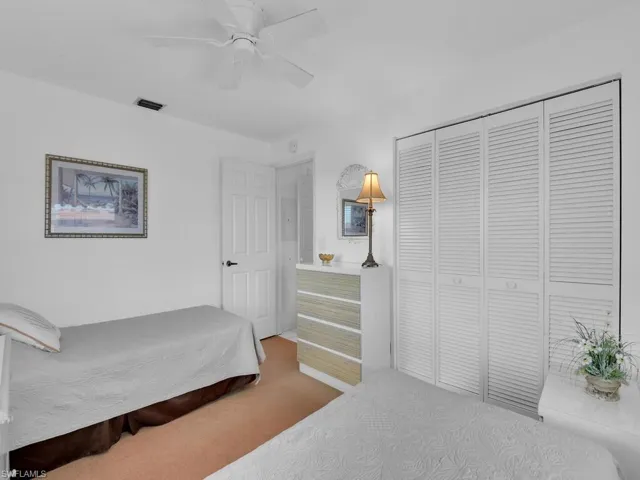 Bedroom featuring carpet floors, a closet, and ceiling fan