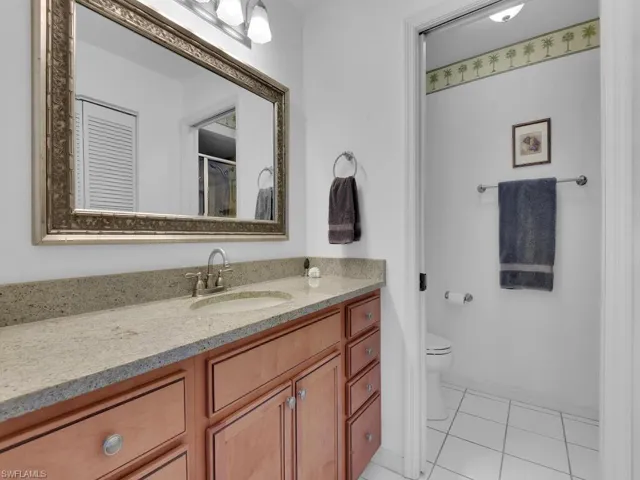 Bathroom with tile patterned flooring, vanity, and toilet