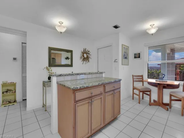 Kitchen featuring light stone counters and light tile patterned floors
