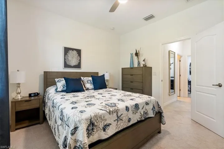 Bedroom with light carpet and ceiling fan