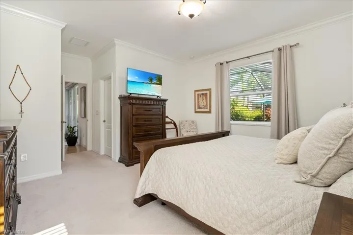 Bedroom featuring ornamental molding and light carpet