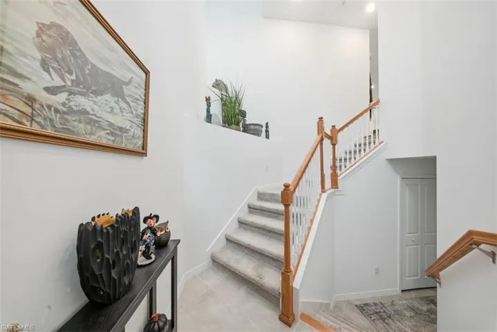Stairs featuring tile patterned floors and baseboards