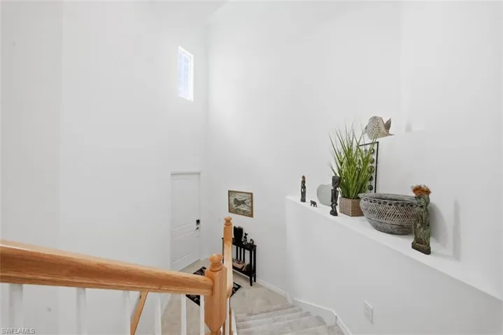 Staircase with carpet flooring and a high ceiling