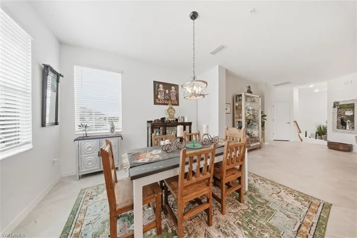 Dining space with a chandelier and light tile patterned floors