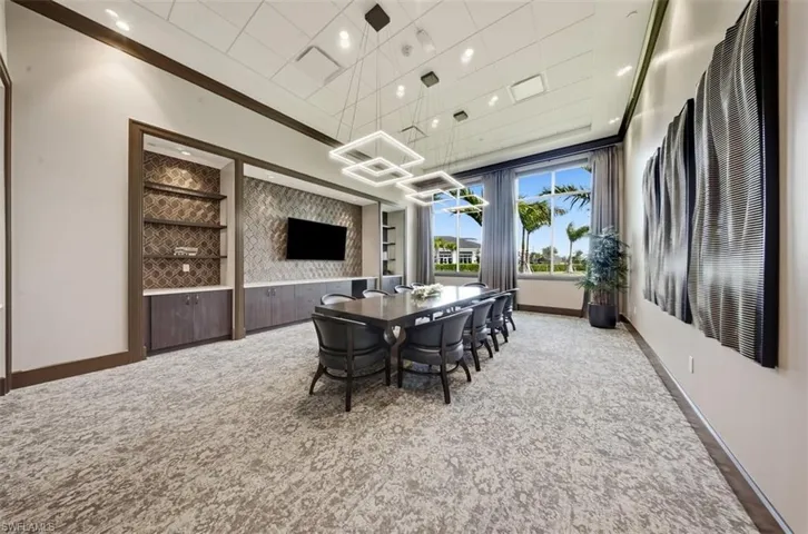 Dining room featuring light colored carpet, ornamental molding, and recessed lighting