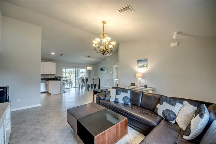 Spacious living area featuring tile flooring and vaulted ceilings