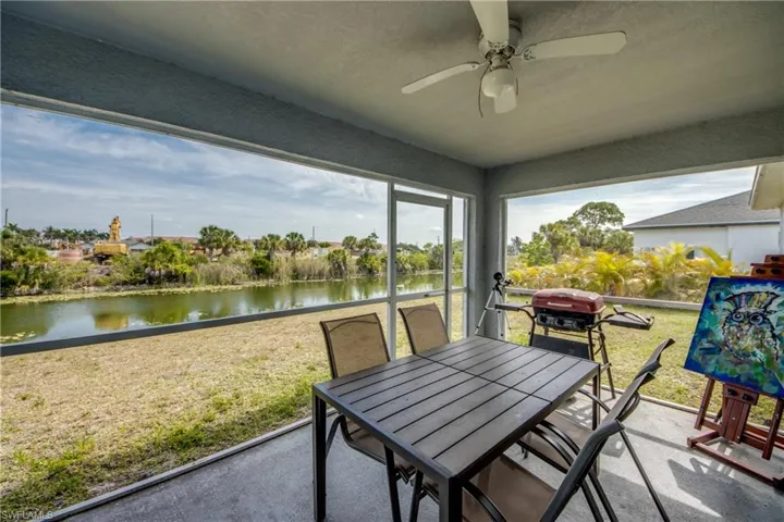 Screened patio with a ceiling fan, offering broad water scenery