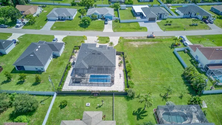 Aerial perspective of suburban area with a pool