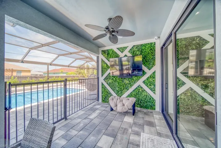 View of patio / terrace with a sunroom, a lanai, and ceiling fan