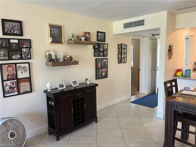 Dining area with light tile patterned floors and baseboards