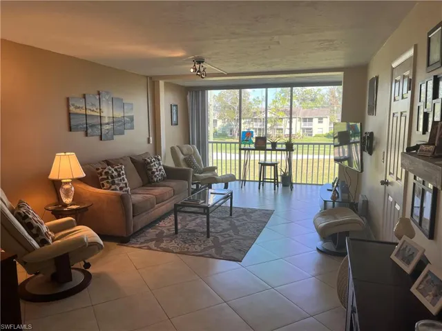 Living area featuring expansive windows and light tile patterned flooring