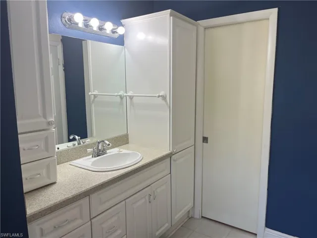 Bathroom with vanity and light tile patterned floors