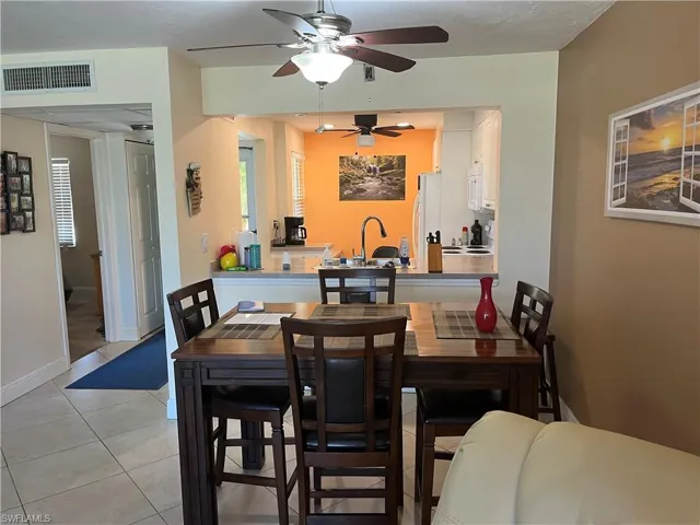 Dining area featuring light tile patterned flooring and baseboards