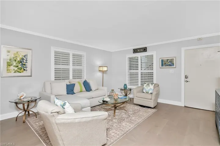 Spacious living and dining room with wood flooring
