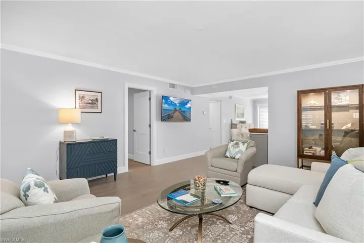 Spacious living and dining room with wood flooring